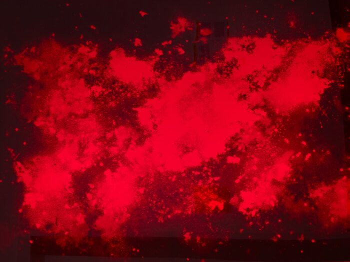 Unfixed Galaxies (2018–2024) by Sema Bekirovic consists of analogue photographic prints created using dust collected from the vacuum cleaners at the Stedelijk Museum. The dust, containing traces of visitors, staff, and artworks, was placed on photographic paper, exposed, developed, but left unfixed. Displayed behind red plexiglass to slow the fading process, the images remain light-sensitive and will eventually disappear if exposed to daylight. The work emphasizes the transience of both people and artworks, highlighting the intimate material traces left behind in shared museum spaces.